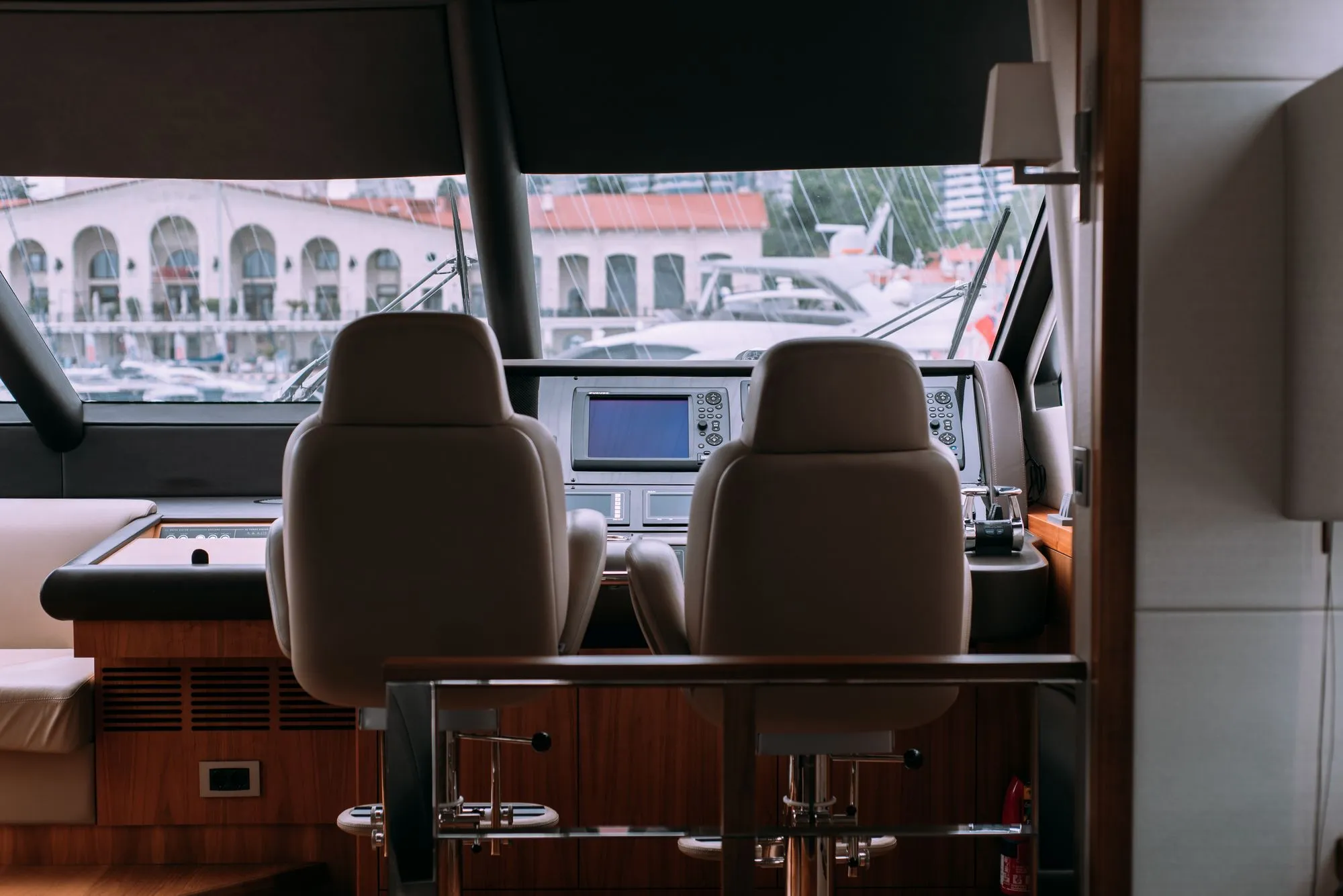 Cream leather helm seats and timber joinery inside a motor yacht